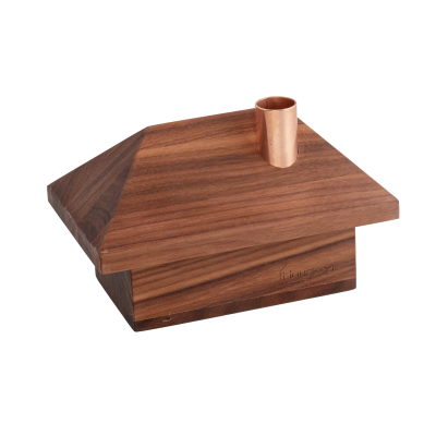 Minimalist wooden train station building with a copper chimney